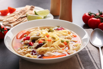 Chicken tortilla soup in plate on kitchen table
