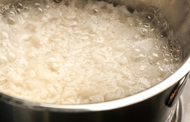 Cooking rice in metal pan, closeup