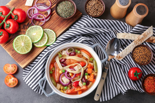 Chicken tortilla soup with vegetables on kitchen table