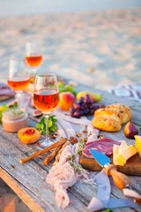 Picnic on the beach at sunset in boho style, food and drink concept © yatcenko