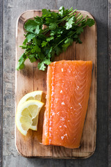 Raw salmon fillet on wooden background
