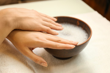 Young woman getting manicure in spa salon, closeup