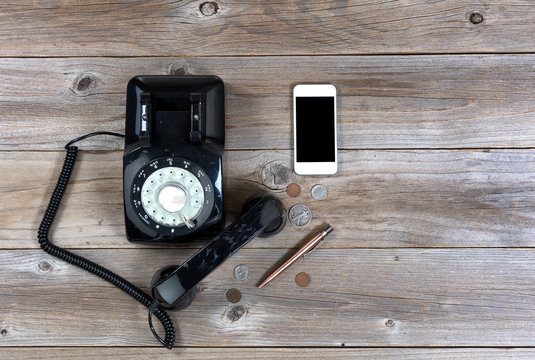 Vintage and modern communication devices on rustic wooden boards