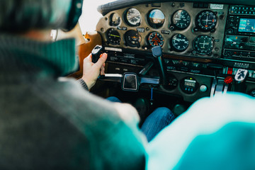 Flight instructor and student inside small Piper aircraft