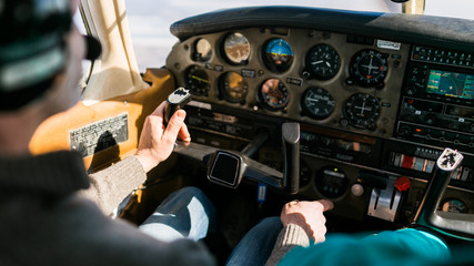 Fototapeta na wymiar Flight instructor and student inside small Piper aircraft