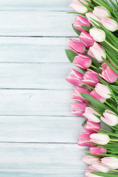 Fototapeta Pink tulips over wooden background