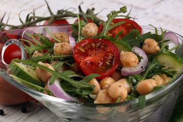 Healthy homemade chickpea and veggies salad, arugula, diet, vegetarian, vegan food, vitamin snack