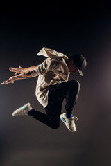 Obraz premium Jumping young male dancer on grey background