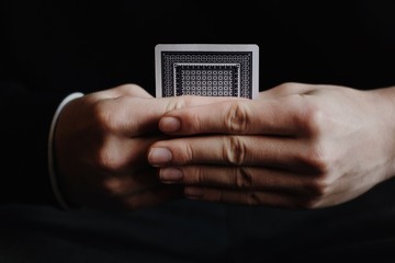 Hand holding hidden playing card - 139861695