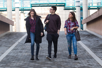 Three students walking in the campus