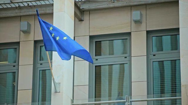 Waving Flag of European Union on Building.
