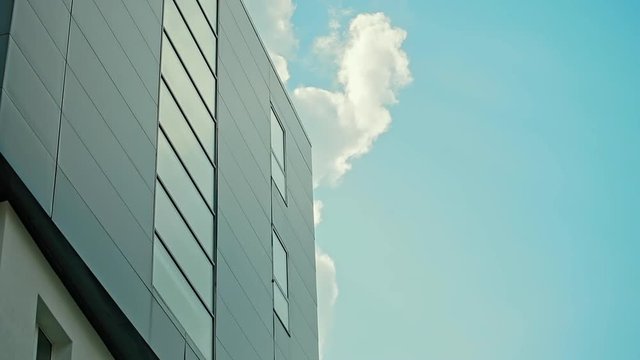 Office Building on the Blue Sky Clouds Background.