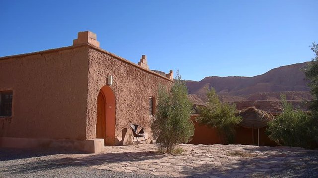 View from the outside of a Riad in Ouarzazate, with the desert in the background