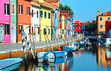 island of Burano and reflection over the navigable channel of th