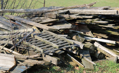large woodshed with many pieces of wood and other wooden materia
