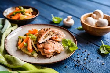Roasted chicken breasts stuffed with mushrooms, cheese and egg, garnished with steamed vegetable