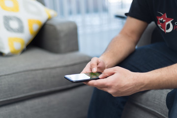 Side profile of a man using iphone 7 