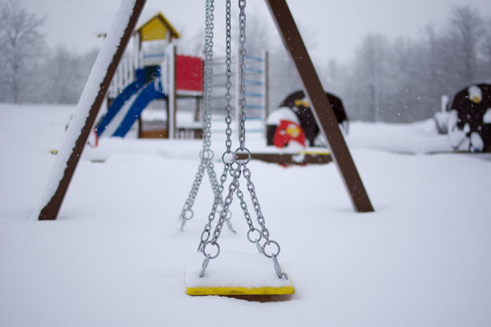 Kids playground covered with snow. Winter landscape on mountain.
