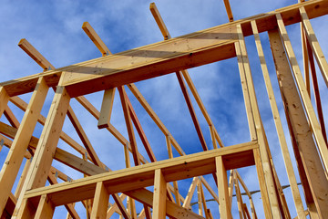 Obraz premium wood frame residential building under construction.