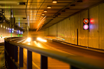 Truck driving through the tunnel by night. Tunnel with speed limit.