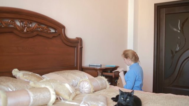 Dishonest maid doing the cleaning in the bedroom.