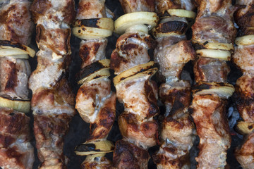Cooking on the coals of juicy meat with onions