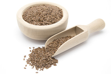 Flaxseeds in wooden scoop and bowl