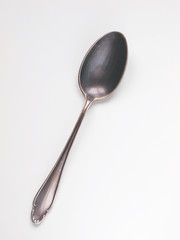 Old silver vintage spoon on white background
