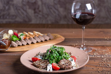 Warm salad with meat and feta