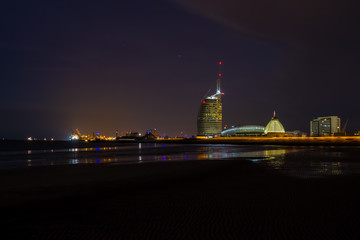 Bremerhaven. City view from the beach with skyline and harbor at night.