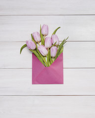Pink tulips on white wooden background