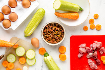 Set of animal food, meat,vegetables and eggs on kitchen top view