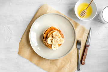 cooked pancake on plate top view at wooden background