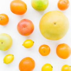 Citrus fruits pattern made of lemon, orange, grapefruit, sweetie and pomelo on white background. Flat lay, top view. Fruit's background