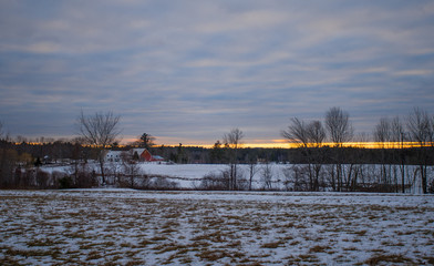 Farm at sunset in snow