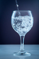 Pure water pouring into a transparent glass