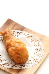 Homemade fried chicken drum stick on wooden plate