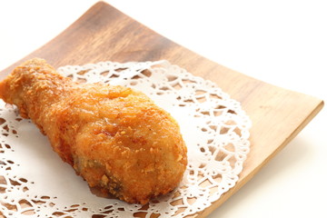 Homemade fried chicken drum stick on wooden plate