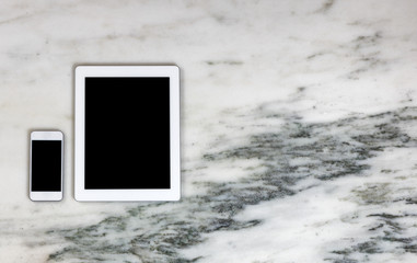 Modern mobile communication devices on marble desktop