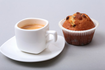 Fresh homemade muffins and white cup of Cappuccino on white background.