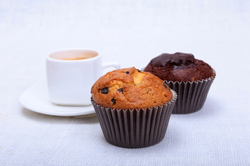 Fresh homemade muffins and white cup of Cappuccino on white background.