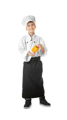 Cute boy in chef uniform on white background