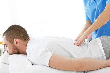 Physiotherapist working with patient in clinic