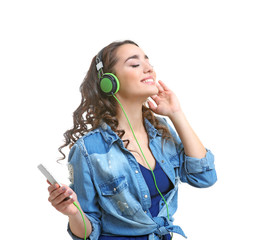 Happy young woman in headphones listening to music on white background