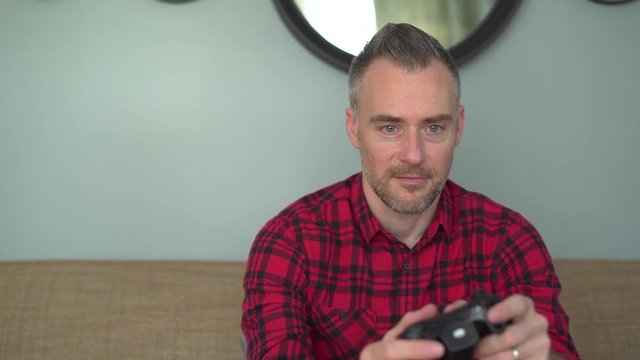 Dolly shot of a man play a video game
