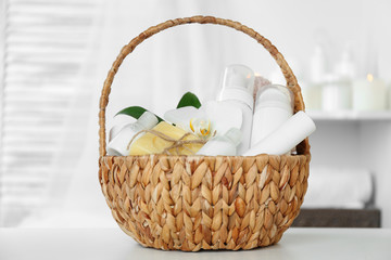 Wicker basket with spa treatments on table