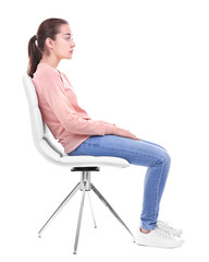 Posture concept. Young woman sitting on chair against white background