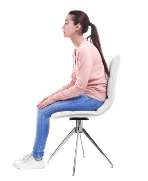 Posture Concept. Young Woman Sitting On Chair Against White Background