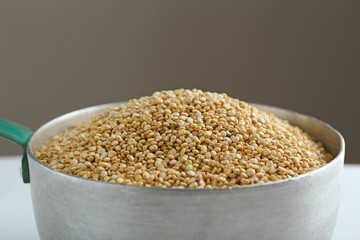Organic quinoa seeds in pan, closeup