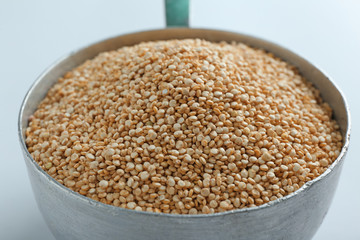 Organic quinoa seeds in pan, closeup